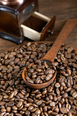 Fototapeta premium grinder and coffee beans with a wooden spoon
