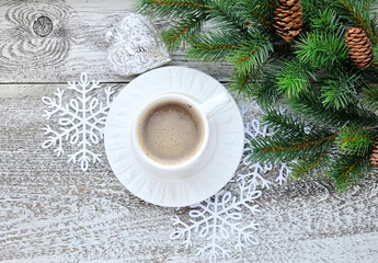 Obraz na płótnie Canvas Cups of coffee and fir branches with christmas decorations on wooden table background