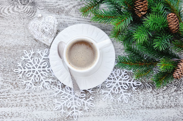 Obraz na płótnie Canvas Cups of coffee and fir branches with christmas decorations on wooden table background