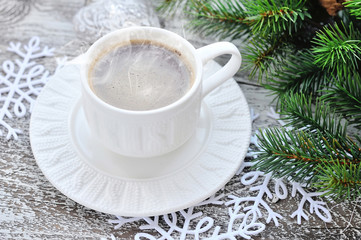 Cups of coffee and fir branches with christmas decorations on wo
