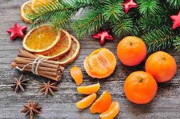 Tangerines and Christmas tree branches on a wooden table. Natura