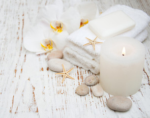 Candle, orchids and towels