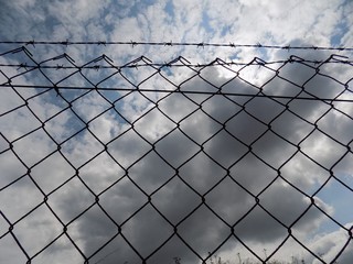 Metallic fence and sky