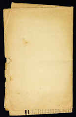 Old grunge folded paper sheet, isolated on black background.