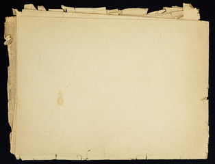 Old grunge folded paper sheet, isolated on black background.