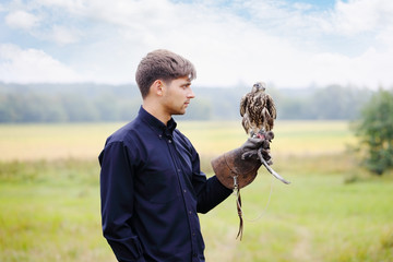 Young  man falcon feeds