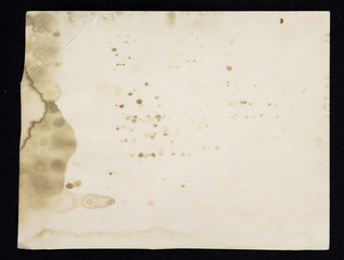 Old grunge paper sheet, isolated on black background.