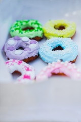 
sweets and colorful donuts in box