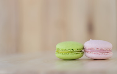 Tasty Sweet Macaroons on wooden background.