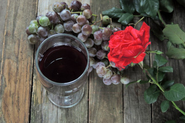 Wine and grapes on a wooden background