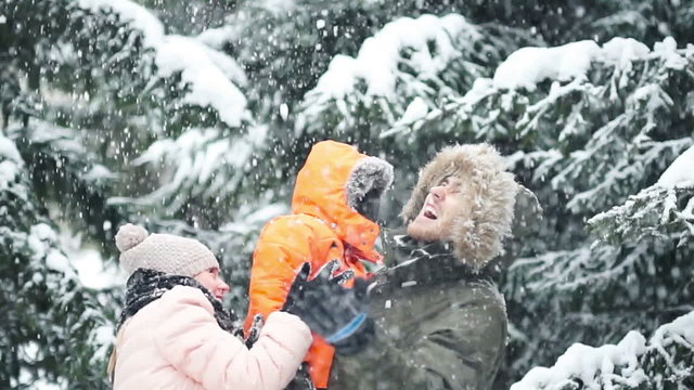 Attractive family having fun in a winter park
