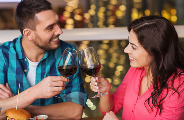 happy couple dining and drink wine at restaurant