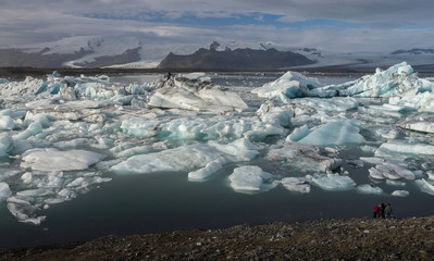 Ice cubes at  Jokulsarlon Glacier Lagoon with snow mountain range background