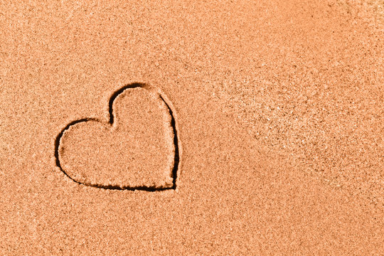 Drawed heart on the beach sand
