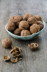 walnuts in a bowl on a wooden surface in a rustic style