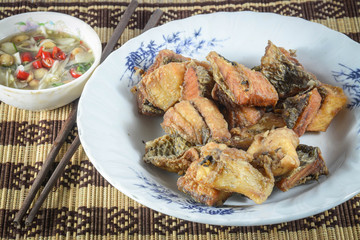 fired fish with fish sauce , thai food