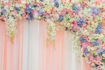 Beautiful flowers over  fabric backdrop  for wedding ceremony