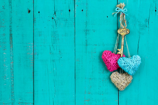 Skeleton key and three rope hearts hanging on door