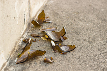 Fragments of glass bottles shattered on the floor. The danger is all around