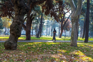 Young Muslim Woman walking in park