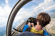 pilot in the cockpit of the plane, glider gliding in the air over cities and countryside