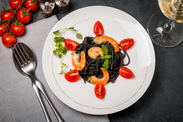 Black spaghetti with prawns and cherry tomatoes