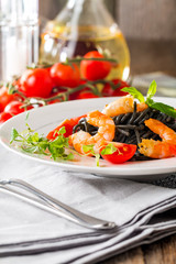Black spaghetti with prawns and cherry tomatoes