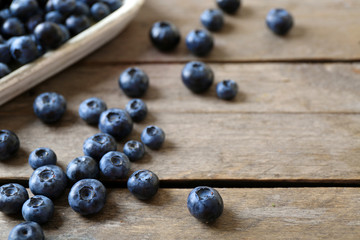 Tasty ripe blueberries on wooden table close up