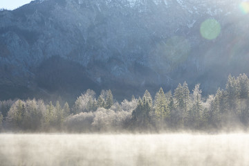Fog above lake Offensee on a sunny winter day