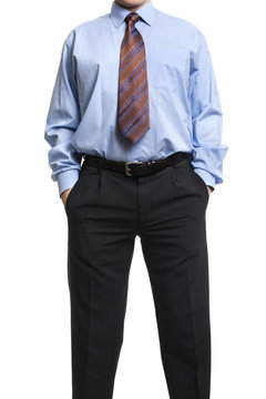 Businessman In Blue Shirt Standing With Hands In Pockets