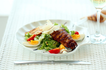Tasty salad on white served table, outdoors