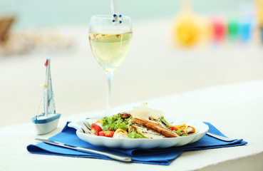 Tasty salad on white served table