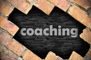 Hole in the brick wall with word coaching