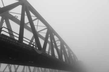 old iron bridge over wrapped in a mysterious fog