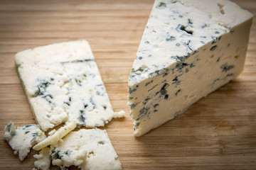 Dorblu Cheese Slice on Wooden Background.
