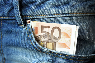 Euro banknotes in jeans pocket closeup