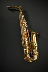Fototapeta na wymiar Beautiful golden saxophone on black background