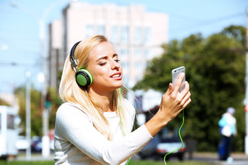 Young woman listening to music outside