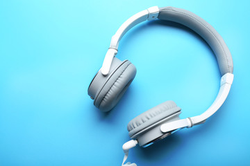 White and grey headphones on blue background