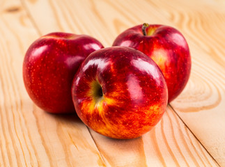 Ripe red apples on wooden background