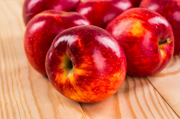 Ripe red apples on wooden background