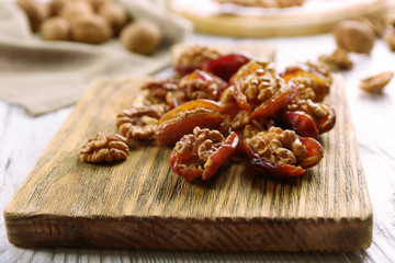 Walnut in date fruit on cutting board, close-up