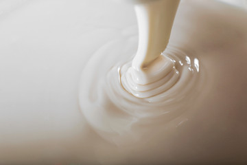 Background of condensed milk in a bowl, close-up