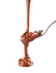 Melted milky brown chocolate pouring from a spoon, isolated on white