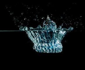 Christmas bell splash in water on black background