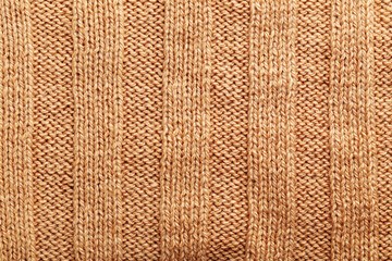 Knitted woolen fabric background, close up