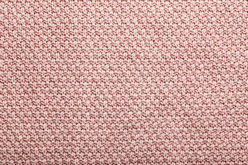 Knitted woolen fabric background, close up