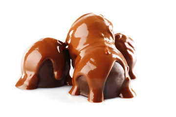 Chocolate poured on candy isolated on white
