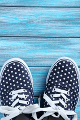 Naklejka premium Female gumshoes on blue wooden background