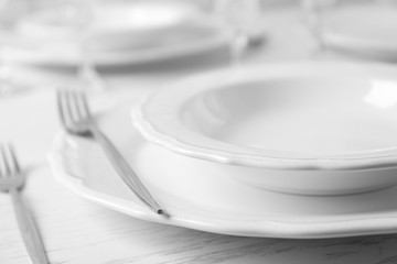 Table set at restaurant on light background